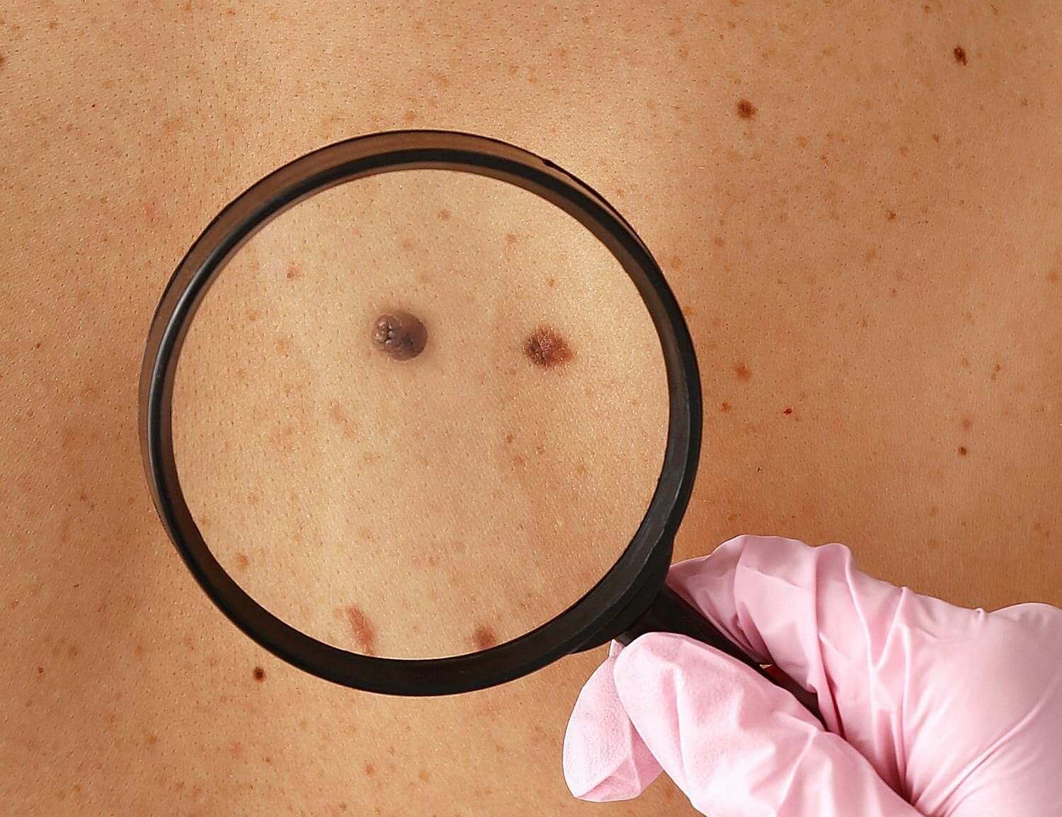 Person with afro hairstyle wearing white shirt.