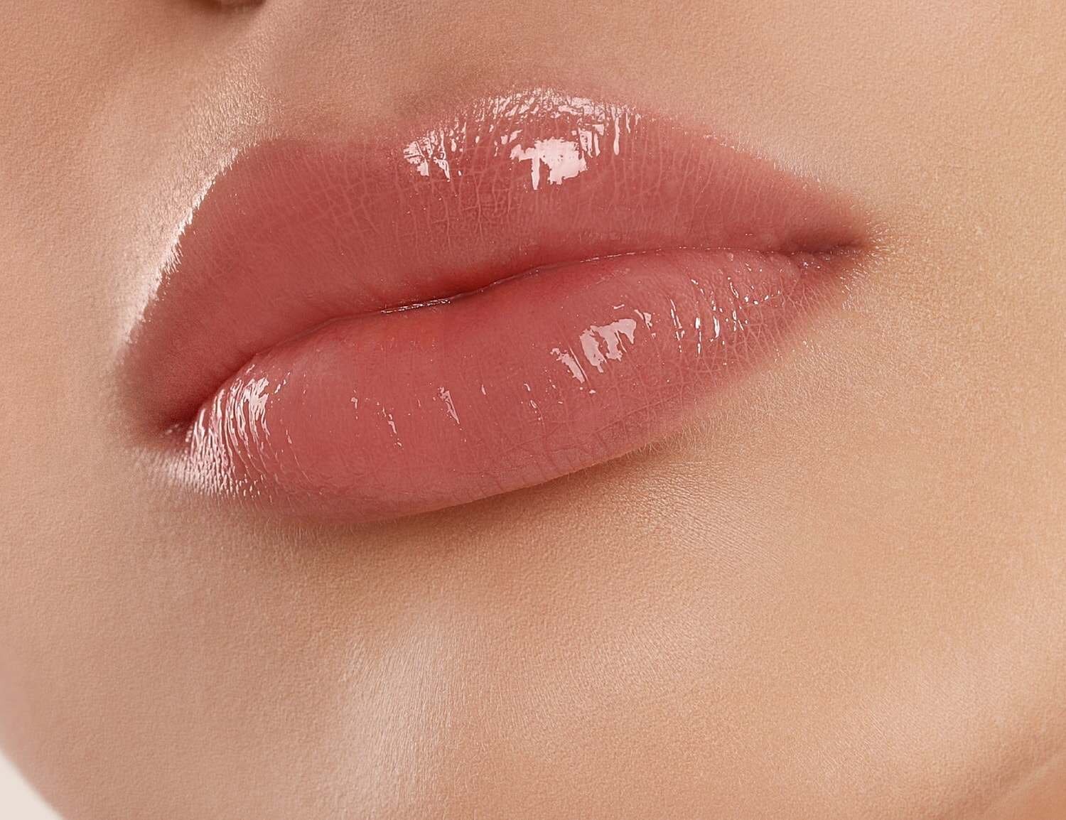 Smiling woman with braided hair, joyful expression.